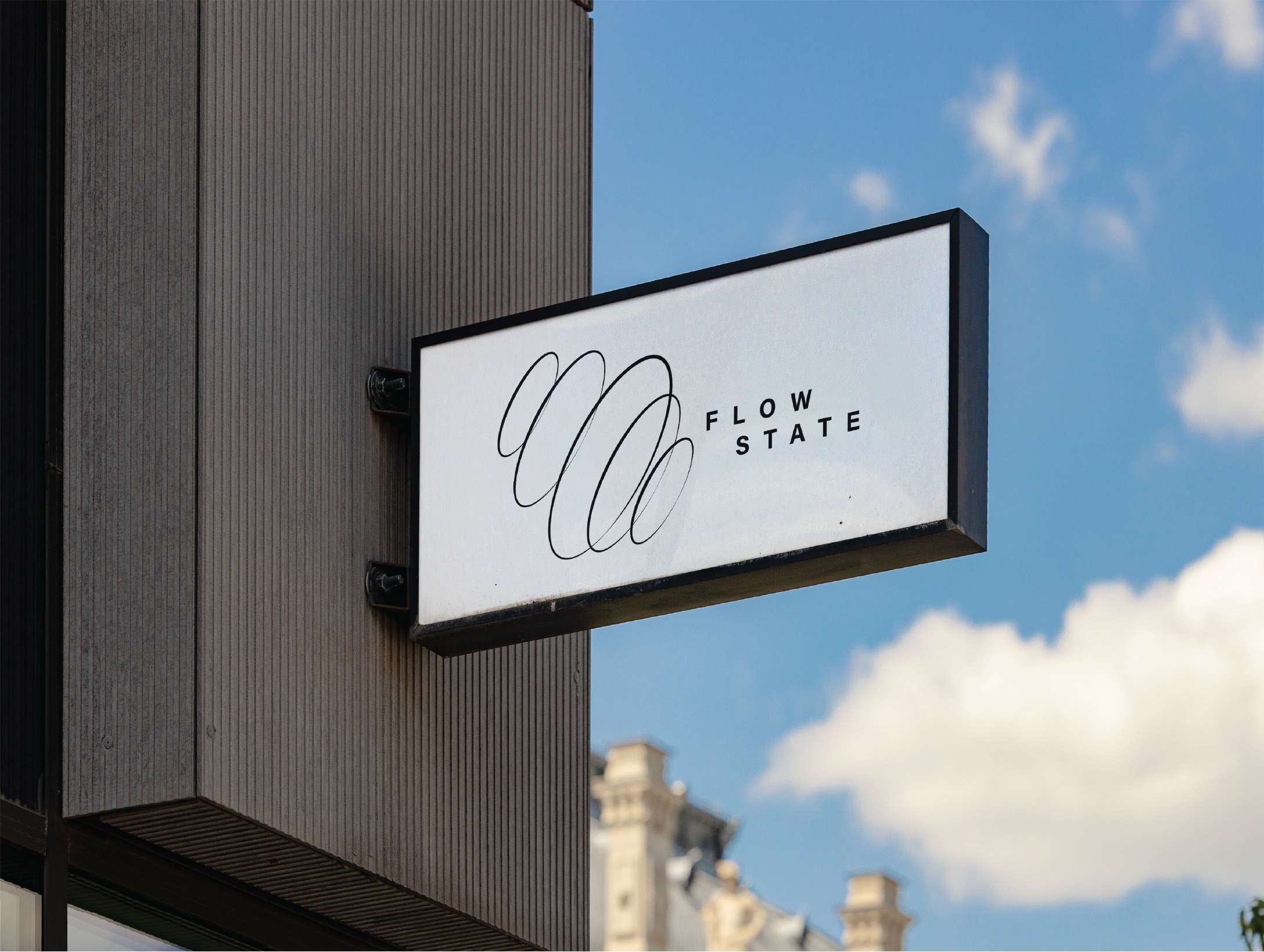 Flowstate Studios brand identity shown on an outdoor hanging sign